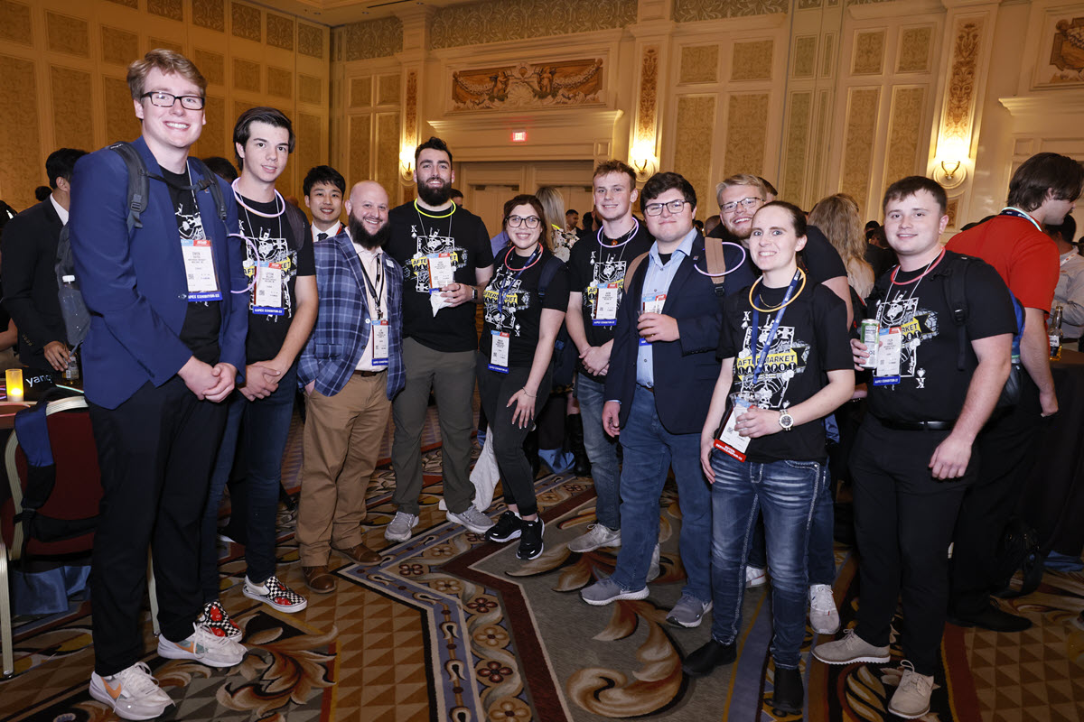 A group of young attendees pose together at an AAPEX event